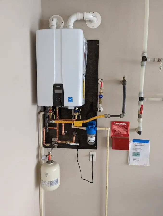 Professional plumber installing copper piping in a Hot Springs Village home